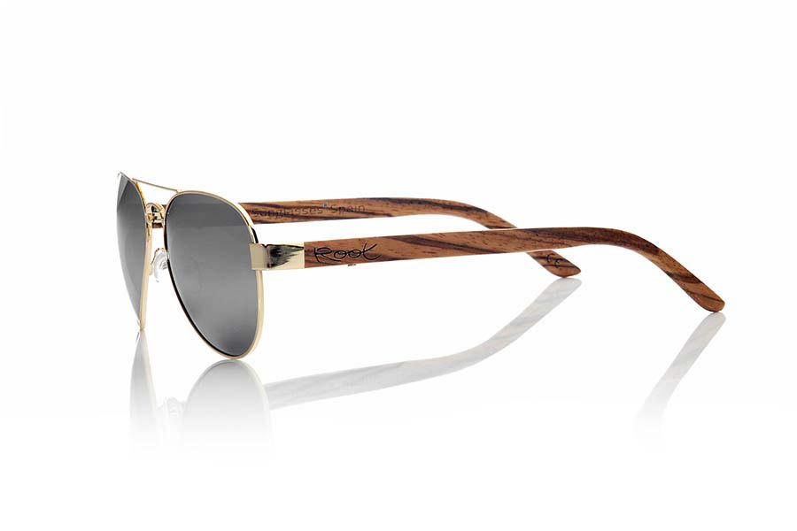 Wood eyewear of Zebrano BERLIN. BERLIN sunglasses are made from the metal frame and sideburns natural Zebrano wood. A classic Aviator style model series combined with yellow lenses REVO, REVO Blue or Gray REVO. You'll love the combination of zebra wood. Front Measure: 150x50mm for Wholesale & Retail | Root Sunglasses® 