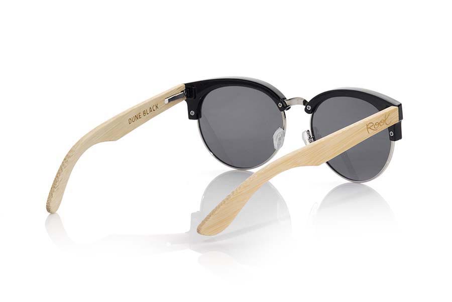 Wood eyewear of Bamboo DUNE BLACK. DUNE BLACK sunglasses are made with black synthetic material front and sideburns in natural bamboo wood, open front, metallic bridge with adjustable nose pads combined with four colors of lenses that will adapt perfectly to your taste and to your modern style. Measure front: 139X49mm for Wholesale & Retail | Root Sunglasses® 