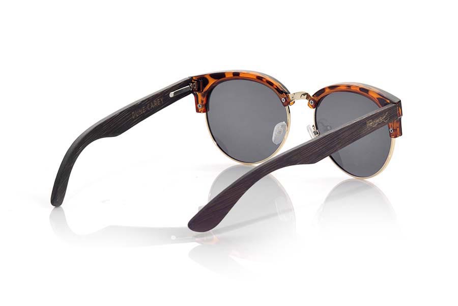 Wood eyewear of Bamboo DUNE CAREY. DUNE TORTOISESHELL sunglasses are made with the front plastic carey and sideburns in bamboo wood stained in dark brown, with the open front, metal bridge and adjustable nose pads combined with four colors of lenses that will adapt perfectly to your taste and to your modern style. Front size: 139X49mm for Wholesale & Retail | Root Sunglasses® 