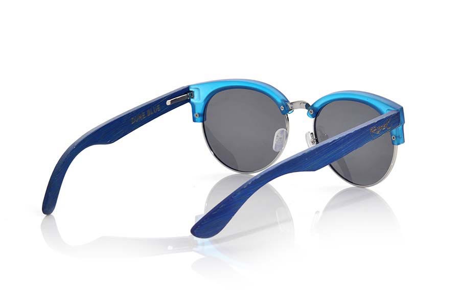 Wood eyewear of  DUNE BLUE. DUNE BLUE sunglasses are made with the front of transparent matte blue synthetic material and sideburns in natural bamboo blue stained, with open front, metal bridge and adjustable nose pads combined with four colors of lenses that will adapt perfectly to your taste and to your modern style. Front size: 139X49mm for Wholesale & Retail | Root Sunglasses® 