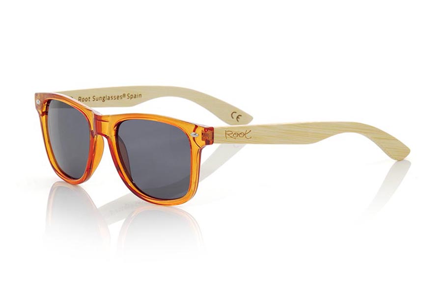 Wood eyewear of Bamboo CANDY ORANGE. Candy Orange sunglasses are made with synthetic dark Orange transparent front and sideburns in natural bamboo combined with four lens colors that will adapt perfectly to your taste and your modern style. Front Measure: 148x50mm for Wholesale & Retail | Root Sunglasses® 