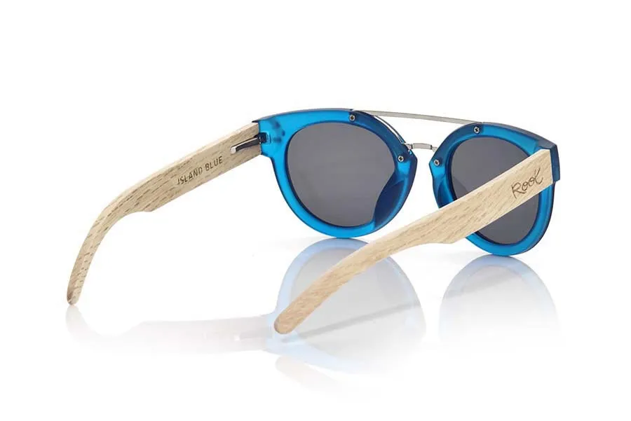 Wood eyewear of  ISLAND BLUE. ISLAND BLUE sunglasses are made with the front of transparent matte blue synthetic material and sideburns in wood of natural duwood of front thickness, attached by a metallic bridge metallic trim in eyebrow combined with four colors of lenses that will adapt perfectly to your taste and to your modern style. Front size: 137X50mm for Wholesale & Retail | Root Sunglasses® 