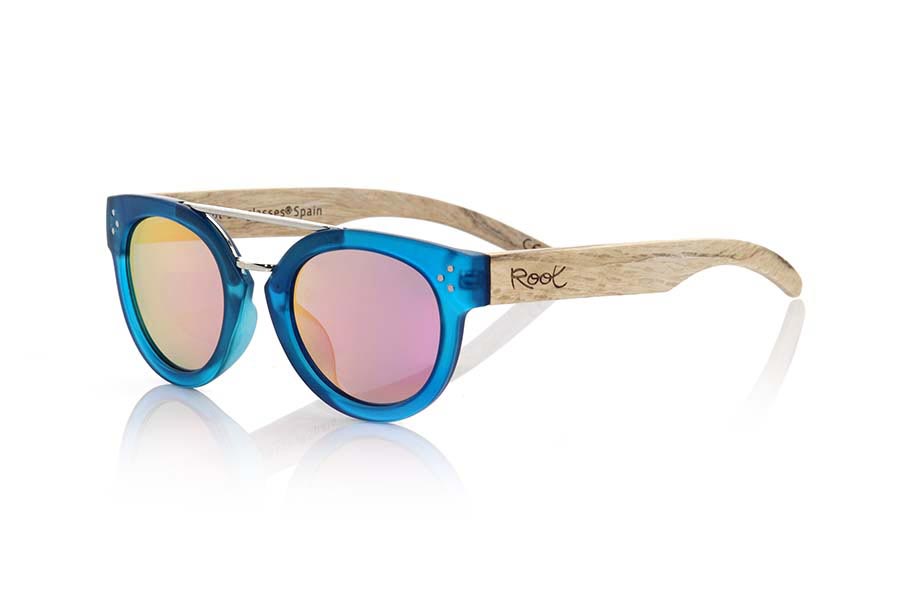 Wood eyewear of  ISLAND BLUE. ISLAND BLUE sunglasses are made with the front of transparent matte blue synthetic material and sideburns in wood of natural duwood of front thickness, attached by a metallic bridge metallic trim in eyebrow combined with four colors of lenses that will adapt perfectly to your taste and to your modern style. Front size: 137X50mm for Wholesale & Retail | Root Sunglasses® 