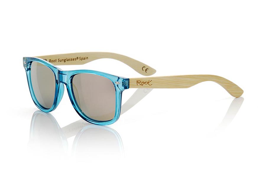 Wood eyewear of Bamboo CANDY BLUE. The Candy Blue sunglasses are made with sinthetic front in blue transparent and sideburns in natural bamboo combined with four lens colors that will adapt perfectly to your taste and your modern style. Front Measure: 148x50mm for Wholesale & Retail | Root Sunglasses® 