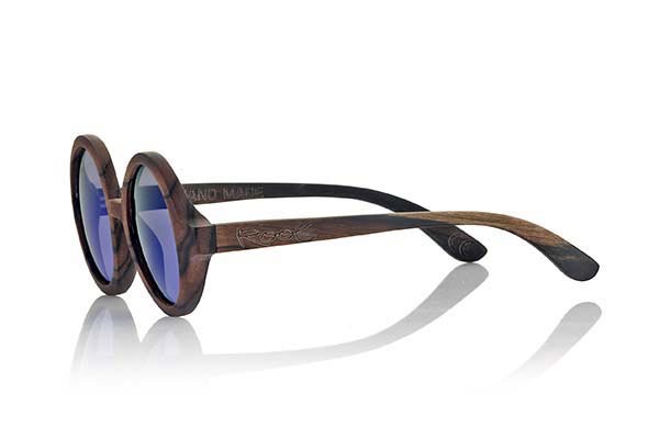 Wood eyewear of Ebony TANA. Tana sunglasses are made of ebony wood. Circular strict model made of a beautiful wood combined with Grey lenses, REVO Grey, Purple REVO or Orange REVO. It will surprise its originality and different lens combinations. Front Measure: 138x55mm for Wholesale & Retail | Root Sunglasses® 