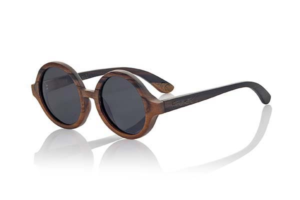 Wood eyewear of Ebony TANA. Tana sunglasses are made of ebony wood. Circular strict model made of a beautiful wood combined with Grey lenses, REVO Grey, Purple REVO or Orange REVO. It will surprise its originality and different lens combinations. Front Measure: 138x55mm for Wholesale & Retail | Root Sunglasses® 