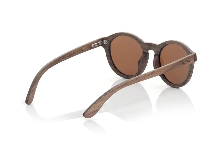 Wood eyewear of Black Walnut ARAPA. The New Arapa sunglasses are manufactured in layered Black Walnut wood, is a model of rounded shapes easy to carry and are combined standard with lenses Grey, Brown or Orange REVO. You'll love its shape, size and beauty of the walnut. Front Measure: 138x50mm for Wholesale & Retail | Root Sunglasses® 