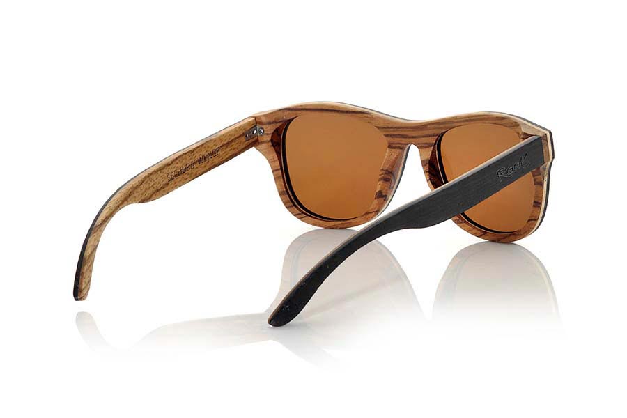 Wood eyewear of Wenge SECHURA. Sechura sunglasses are made with Wenge, Maple and  Zebra wood combined. The front of the Sechura is Wenge wood on the outside and zebra wood inside the front leads sandwiched a thin layer of clear maple wood. Meanwhile the pins are made of wood Wenge outside and Zebrano  inside. You will be surprised the quality of this frame and the combination of woods. They come standard with Gray, Brown or Orange REVO lenses. Front Measure: 143x47mm for Wholesale & Retail | Root Sunglasses® 