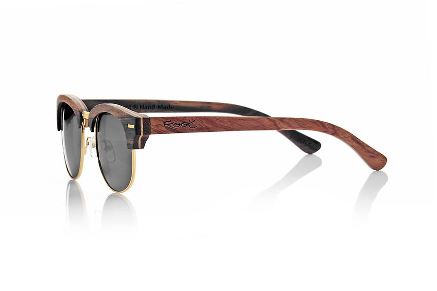 Wood eyewear of Ebony ICARO. ICARO sunglasses are made of a combination of three wood, ebony, maple and rosewood combined in different layers. the front comes in ebony wood an intermediate layer of maple wood and the inside of Rosewood while on pins this pattern being rosewood on the outside and ebony wood inside is reversed. It is a unisex open lower ring with a gold standard Tanao that adapts to all kinds of faces and people model. The've combined with various types of PC lenses. Front Measure: 143x46mm for Wholesale & Retail | Root Sunglasses® 