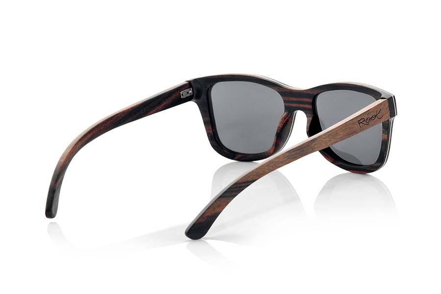 Wood eyewear of Ebony DANAKIL. Danakil sunglasses are made in solid ebony wood with a thin sheet of aluminum foil sandwiched between the mount what gives this model, along with an attractive metallic tap the side that combined with this beautiful wood gives a plus of elegance , an extra resistance and allows a finer frame being approximately 4.5mm in thickness. The Danakil are somewhat oversized model looks great in wider or round face. You'll be amazed the beauty of wood elegant touch metal on the sides and fine mount. DANAKIL sunglasses include a practical folding case that keeps your glasses safe when they are  inside and takes up very little space when folded. Front Measure: 147x50mm for Wholesale & Retail | Root Sunglasses® 