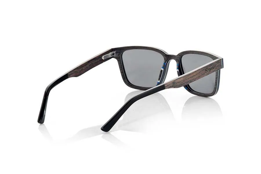 Wood eyewear of Black Walnut SANDY. SANDY sunglasses are a unique and elegant model. Made with very thin sheets of black walnut wood, these glasses incorporate a very thin sheet of aluminum between the sheets of wood on the front. The result is an ultra-thin spectacle only 3.8mm thick and ultra-light, weighing only 16 grams. In addition, the aluminum reinforcement gives it extra resistance and a very elegant metallic touch on the sides. The temples are finished in quality acetate, which allows them to be adjusted if necessary. You will be surprised by the beauty of the wood and its sexy angular lines, they also <b>have a system for mounting prescription lenses</b>. Front measurement of 139x43mm for Wholesale & Retail | Root Sunglasses® 