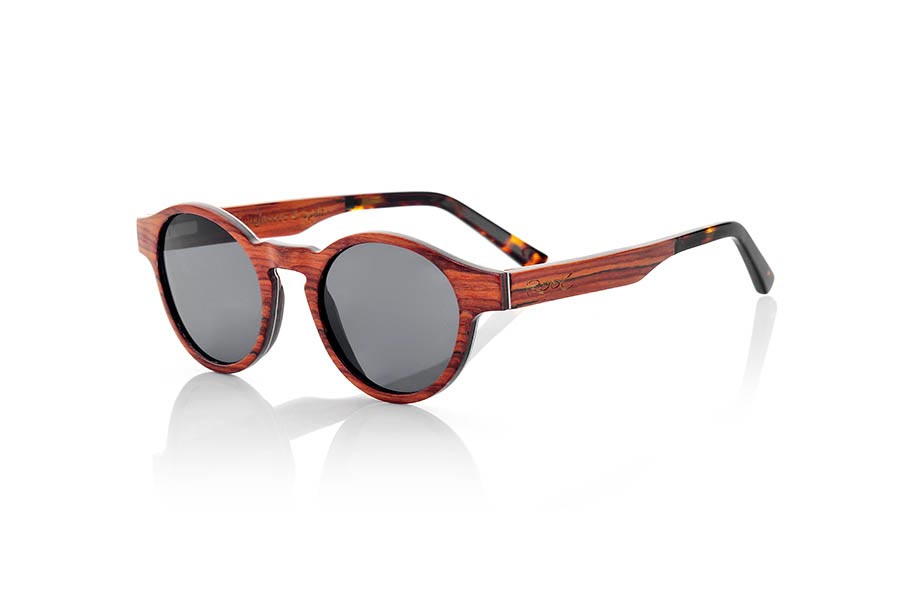 Wood eyewear of Rosewood modelo BASIN. BASIN sunglasses are made from thin sheets of wood Rosewood. Incorporate a thin aluminum foil between the wooden slats on the front along with a blue colored sheet. The BASIN goggle is a model with rounded peaks marked on the sides, an optimized for all types of faces of both men and women size. The rods are finished in ethyl tortoiseshell quality allowing its adjustment if necessary. The BASIN are ultra thin with only 3.2mm thick ultra light only 17gr and aluminum reinforcement brings a plus endurance plus a metallic touch in very elegant side. You'll be amazed the beauty of wood thinness and lightness and comfort. BASIN sunglasses include a practical folding case that keeps your glasses safe when they are  inside and takes up very little space when folded. Front Measure: 141x47mm | Root Sunglasses® 