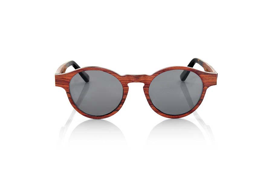 Wood eyewear of Rosewood BASIN. BASIN sunglasses are made from thin sheets of wood Rosewood. Incorporate a thin aluminum foil between the wooden slats on the front along with a blue colored sheet. The BASIN goggle is a model with rounded peaks marked on the sides, an optimized for all types of faces of both men and women size. The rods are finished in ethyl tortoiseshell quality allowing its adjustment if necessary. The BASIN are ultra thin with only 3.2mm thick ultra light only 17gr and aluminum reinforcement brings a plus endurance plus a metallic touch in very elegant side. You'll be amazed the beauty of wood thinness and lightness and comfort. BASIN sunglasses include a practical folding case that keeps your glasses safe when they are  inside and takes up very little space when folded. Front Measure: 141x47mm for Wholesale & Retail | Root Sunglasses® 