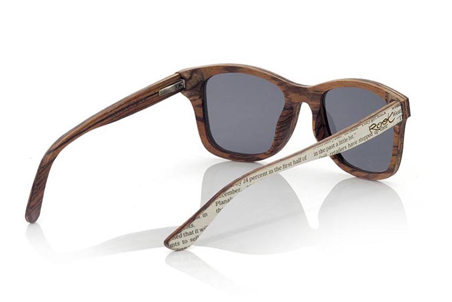 Wood eyewear of Zebrano SILOLI. SILOLI sunglasses are manufactured with Zebrano wood and both the front com pins have been coated recycled pages of newspapers treated with varnish to protect the news ink. If all of our glasses are unique and unrepeatable, these still more since they are all quite different depending on the page of the newspapers which they are made, so the received model may differ from the one shown. This model original exclusive an39 elegant. Front size: 146x48mm for Wholesale & Retail | Root Sunglasses® 