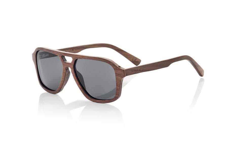 Wood eyewear of Black Walnut MINDANAO. MINDANAO sunglasses are made of Dark Oak wood. The front of this sunglass is broad recalls the famous Aviator model but with forms more angular is simple and elegant thanks to the wonderful veining of the wood with which it is made.  The pins are very fine and elegant and are manufactured in wood of oak dark.  MINDANAO are ready to mount optic Lenses. You will surprise the lightness of this glass, its elegance and the banned of the wood. Measure front: 140x48mm for Wholesale & Retail | Root Sunglasses® 