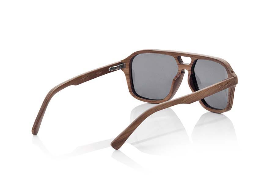 Wood eyewear of Black Walnut MINDANAO. MINDANAO sunglasses are made of Dark Oak wood. The front of this sunglass is broad recalls the famous Aviator model but with forms more angular is simple and elegant thanks to the wonderful veining of the wood with which it is made.  The pins are very fine and elegant and are manufactured in wood of oak dark.  MINDANAO are ready to mount optic Lenses. You will surprise the lightness of this glass, its elegance and the banned of the wood. Measure front: 140x48mm for Wholesale & Retail | Root Sunglasses® 