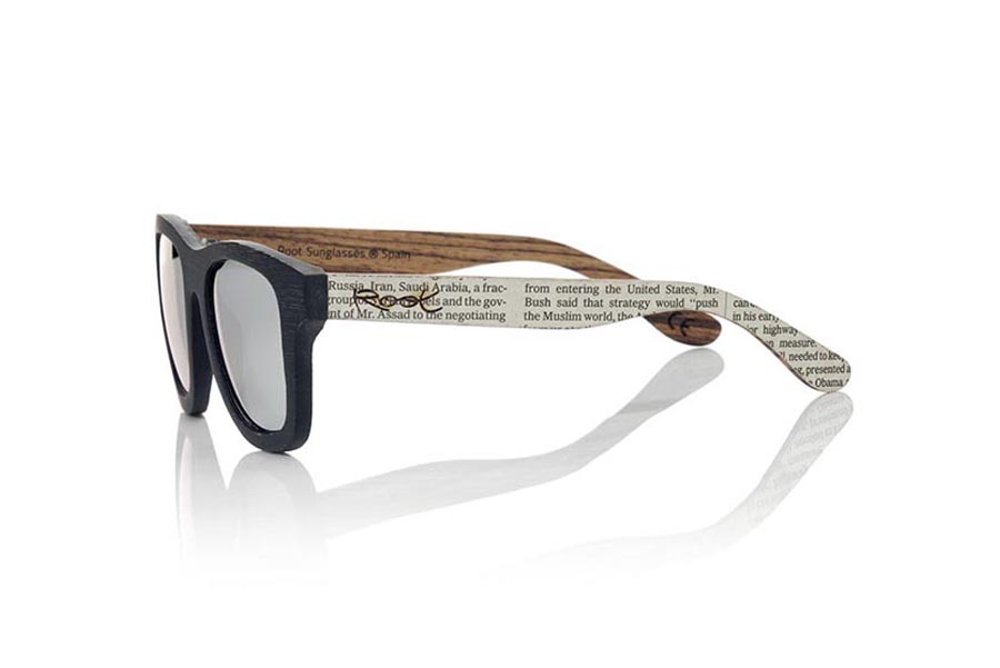 Wood eyewear of Bamboo SANS S. SANS S sunglasses made of bamboo wood combining the front in natural bamboo with a black tinted with natural zebra wood sideburns coated with NEWSPAPERS pages, is a classic mount with a small size for people who the smaller glasses feel better. The SANS S are a ORIGINAL. The SANS S are an even more exclusive model since all the pages of newspapers used are different between. For this reason the model received may not be exactly the same as the model shown.  Frontal measurement: 136x44mm for Wholesale & Retail | Root Sunglasses® 