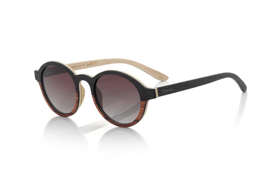 Wood eyewear of mpingo MISTRAL. The MISTRAL sunglasses are made from a combination of MPINGO and sandalwood. The front of this soft-line glass is made by combining Mpingo laminated wood in the upper part and white sandalwood in the lower area.  The sideburns are fine made with the exterior in Mpingo and maple wood inside. You will be surprised by the design and the beauty of the woods. Frontal measurement: 145x50mm for Wholesale & Retail | Root Sunglasses® 
