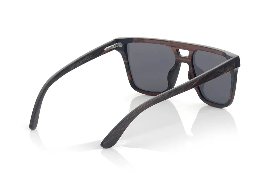 Wood eyewear of ebony RIAD. RIAD sunglasses are made of natural ebony wood. It is a square model with a total lens and a very subtle wooden frame with the pierced bridge of a masculine character but surely some of them also like it. Large in size, RIADs surprise by the beauty of wood in combination with the Total lens. Front measurement: 145x50mm for Wholesale & Retail | Root Sunglasses® 