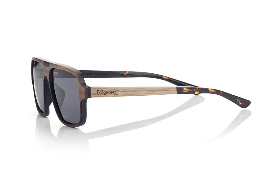 Wood eyewear of Walnut RALPH. RALPH sunglasses are manufactured in a combination of two very beautiful woods, Walnut on the top of the frame and sideburns and Ebony on the bottom of the frame and in the upper central decorative element. The pins are finished in hawksbill acetate with internal rod which allow to be adjusted if necessary. With elegant square shapes, you will love the combination of wood together with its suggestive and elegant shape. Front measure: 141x48mm for Wholesale & Retail | Root Sunglasses® 