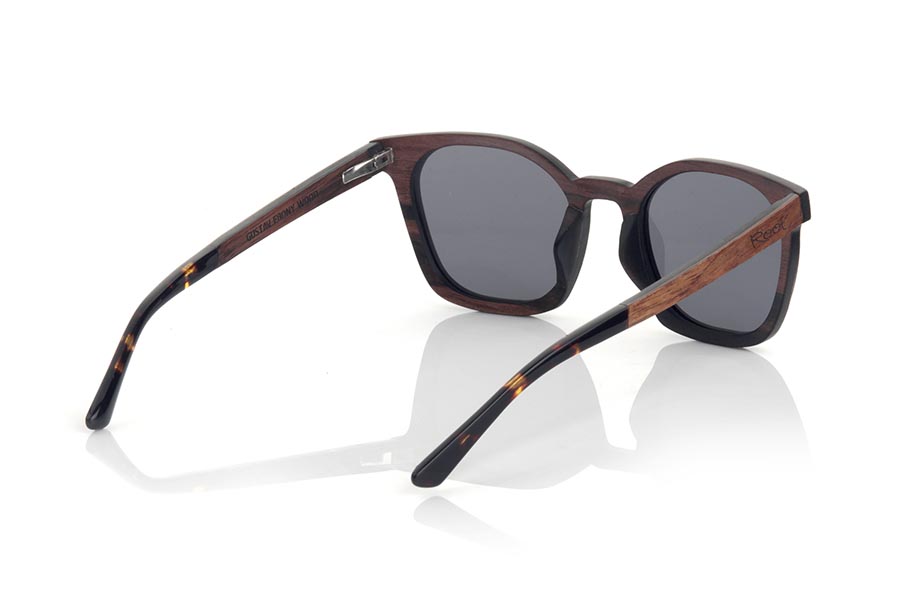 Wood eyewear of ebony GUSTAV. GUSTAV sunglasses are manufactured in a combination of two woods, ebony in the frame and inside of the temples and Rosewood in the outer ring of the frame and the outside of the temples. The latter are finished in carey acetate with internal rod which allow to be adjusted if necessary. It is a model with its own personality and a very careful finish that will surprise you with its originality and the combination of woods. Front measurement: 141x48mm for Wholesale & Retail | Root Sunglasses® 