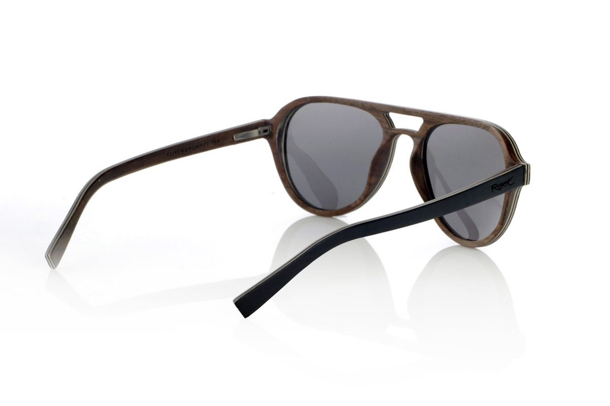 Wood eyewear of Ebony FLYER SK. FLYER SK sunglasses are handcrafted entirely from laminated wood, combining ebony, walnut and zebrawood. Their aviator-inspired design maintains a classic aesthetic with a distinctive bridge, providing a balance between style and functionality.
The laminated wood structure enhances the natural grain of each material, providing an organic and lightweight finish. Thanks to its layered construction, this model offers strength and comfort for daily use.
High-quality polarized lenses guarantee total UV protection and reduce glare, improving visual clarity. A timeless design that connects with nature without sacrificing protection and comfort.
Dimensions 144x52mm. Caliber 53. for Wholesale & Retail | Root Sunglasses® 