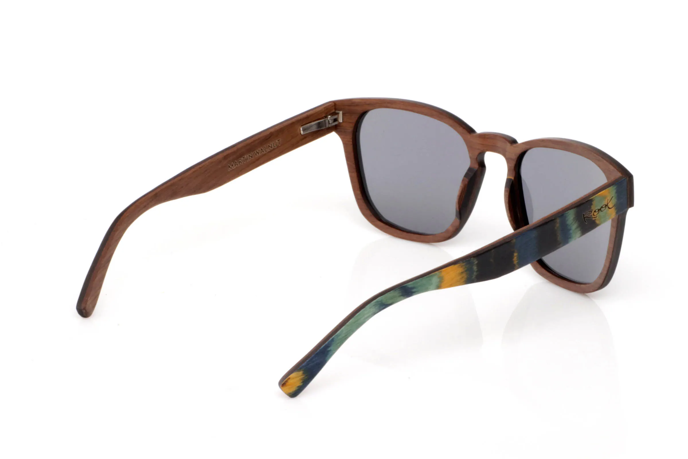 Wood eyewear of Maple MARTIN SK. MARTIN wooden sunglasses feature a soft square shape combined with a design full of nuance. The front blends greens, blues and warm tones flowing irregularly across the frame, creating a unique piece that changes with the light.

The contrast with the natural wood temples brings balance and calm, keeping that organic essence that defines Root.

It’s a frame with personality yet easy to wear, made for those who want to move beyond the basics without losing natural style.

Full UV protection.

Size: 146x52
Lens width: 54 for Wholesale & Retail | Root Sunglasses® 