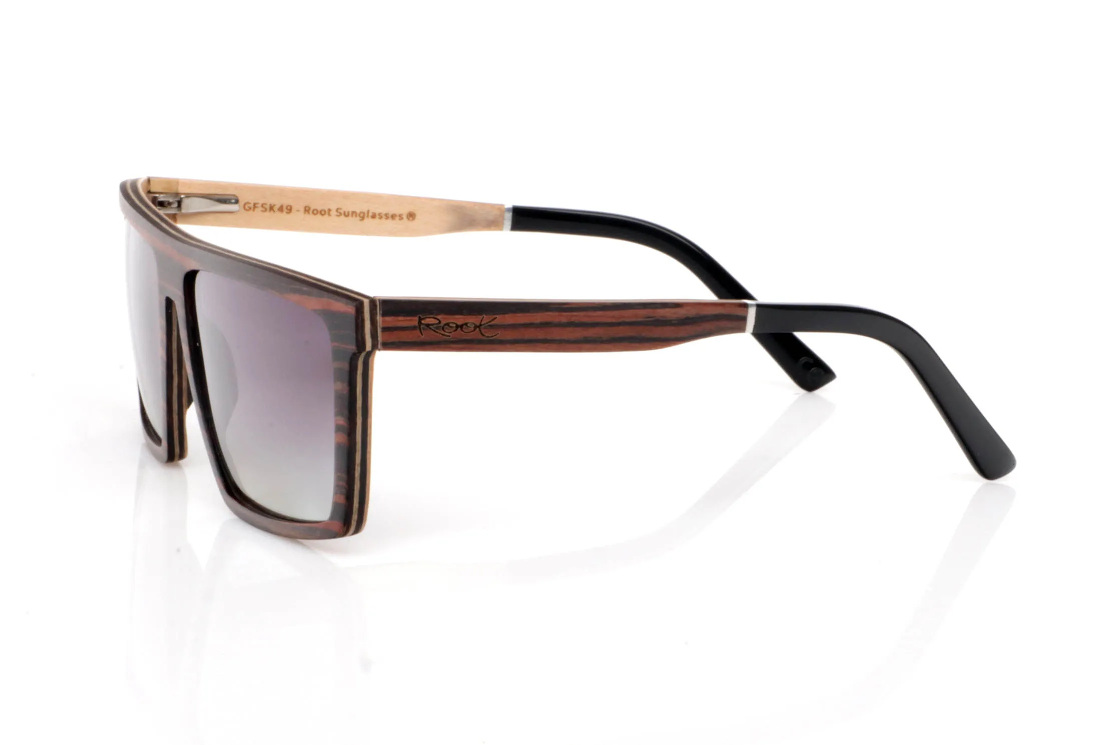 Wood eyewear of ebony IGNAT. IGNAT wooden sunglasses stand out with a wide, geometric front, featuring clean and defined lines that give them a strong and contemporary presence. The dark, contrasted grain of ebony enhances this solid and elegant character without excess.

The design plays with flat surfaces and sharp angles, creating a modern silhouette that fits especially well on medium to wide faces. Despite their bold look, they remain lightweight and comfortable thanks to the wooden construction.

The contrast between the ebony exterior and the lighter inner wood adds visual depth and a refined finish.

A frame with personality, made to stand out while staying natural.

Full UV protection.

Size: 145x49
Lens width: 58 for Wholesale & Retail | Root Sunglasses® 