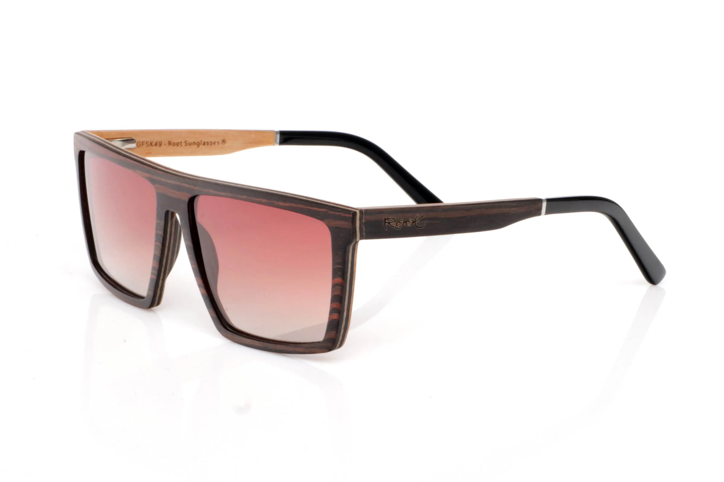 Wood eyewear of ebony modelo IGNAT. IGNAT wooden sunglasses stand out with a wide, geometric front, featuring clean and defined lines that give them a strong and contemporary presence. The dark, contrasted grain of ebony enhances this solid and elegant character without excess.

The design plays with flat surfaces and sharp angles, creating a modern silhouette that fits especially well on medium to wide faces. Despite their bold look, they remain lightweight and comfortable thanks to the wooden construction.

The contrast between the ebony exterior and the lighter inner wood adds visual depth and a refined finish.

A frame with personality, made to stand out while staying natural.

Full UV protection.

Size: 145x49
Lens width: 58 | Root Sunglasses® 