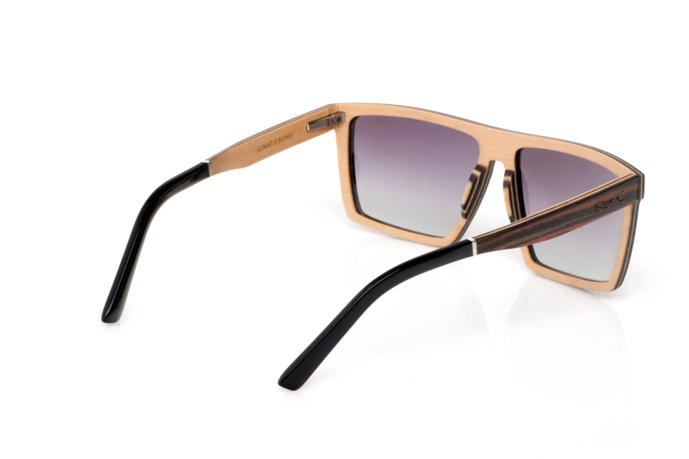 Wood eyewear of ebony IGNAT. IGNAT wooden sunglasses stand out with a wide, geometric front, featuring clean and defined lines that give them a strong and contemporary presence. The dark, contrasted grain of ebony enhances this solid and elegant character without excess.

The design plays with flat surfaces and sharp angles, creating a modern silhouette that fits especially well on medium to wide faces. Despite their bold look, they remain lightweight and comfortable thanks to the wooden construction.

The contrast between the ebony exterior and the lighter inner wood adds visual depth and a refined finish.

A frame with personality, made to stand out while staying natural.

Full UV protection.

Size: 145x49
Lens width: 58 for Wholesale & Retail | Root Sunglasses® 