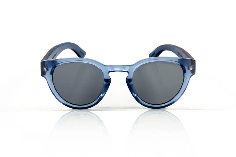 Wood eyewear of Walnut JANE. JANE Sunglasses with walnut wood temples, a translucent blue PC front, and a blue-tinted maple wood interior finish that matches the front. A model that stands out for its lightweight, modern, and balanced design suitable for smaller faces, perfect for those seeking style without sacrificing natural materials. Polarized lenses with UV protection for optimal visual comfort. Measurements: 139 x 50 mm. Caliber 47. for Wholesale & Retail | Root Sunglasses® 