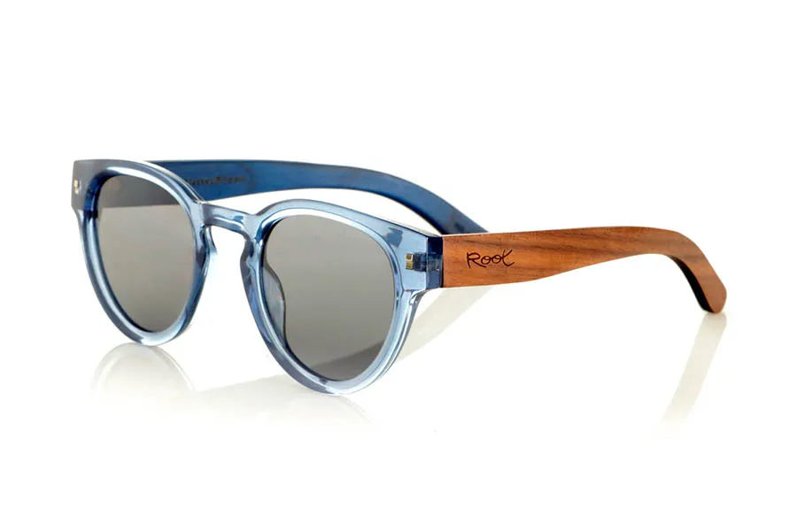 Wood eyewear of Walnut JANE. JANE Sunglasses with walnut wood temples, a translucent blue PC front, and a blue-tinted maple wood interior finish that matches the front. A model that stands out for its lightweight, modern, and balanced design suitable for smaller faces, perfect for those seeking style without sacrificing natural materials. Polarized lenses with UV protection for optimal visual comfort. Measurements: 139 x 50 mm. Caliber 47. for Wholesale & Retail | Root Sunglasses® 