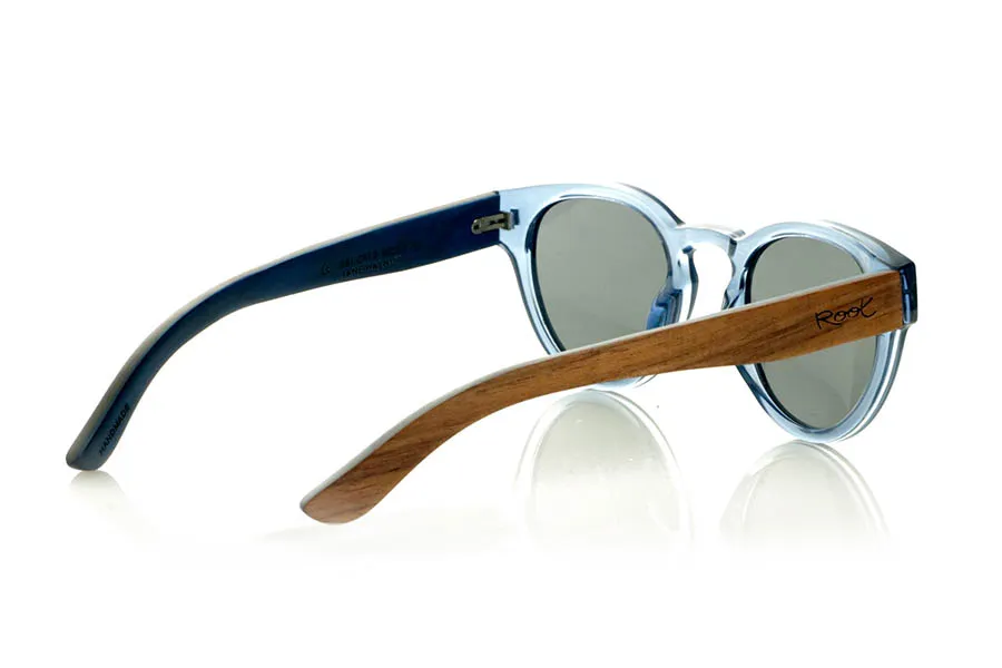Wood eyewear of Walnut JANE. JANE Sunglasses with walnut wood temples, a translucent blue PC front, and a blue-tinted maple wood interior finish that matches the front. A model that stands out for its lightweight, modern, and balanced design suitable for smaller faces, perfect for those seeking style without sacrificing natural materials. Polarized lenses with UV protection for optimal visual comfort. Measurements: 139 x 50 mm. Caliber 47. for Wholesale & Retail | Root Sunglasses® 
