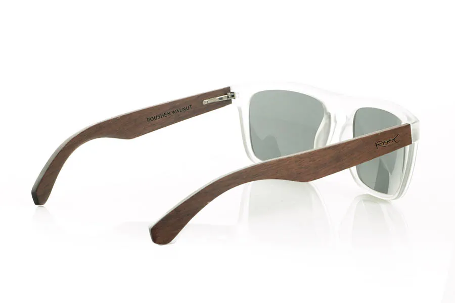 Wood eyewear of Walnut ROUSHEN. ROUSHEN sunglasses with solid dark walnut wood temples and a matte transparent front for a fresh, contemporary look. The contrast between the warmth of the wood and the transparency of the front makes them an original and versatile choice for everyday wear. Polarized lenses with UV protection. Measurements: 145 x 49 mm. Caliber 56 for Wholesale & Retail | Root Sunglasses® 