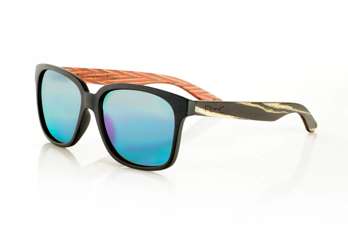 Wood eyewear of Zebrano PABLO. PABLO Sunglasses with laminated black Zebrawood (Black Ice Tree) temples with its characteristic light grain, and a multicolored skateboard-style interior. The matte black front adds a sober touch that contrasts with the vibrant interior, resulting in a modern and original design. Lightweight and comfortable for everyday wear, with polarized lenses and UV protection for greater comfort and visual safety. Measurements: 143 x 50 mm. Caliber 55. for Wholesale & Retail | Root Sunglasses® 