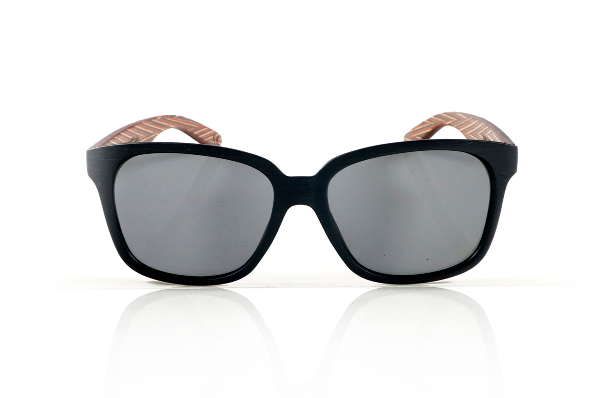 Wood eyewear of Zebrano PABLO. PABLO Sunglasses with laminated black Zebrawood (Black Ice Tree) temples with its characteristic light grain, and a multicolored skateboard-style interior. The matte black front adds a sober touch that contrasts with the vibrant interior, resulting in a modern and original design. Lightweight and comfortable for everyday wear, with polarized lenses and UV protection for greater comfort and visual safety. Measurements: 143 x 50 mm. Caliber 55. for Wholesale & Retail | Root Sunglasses® 