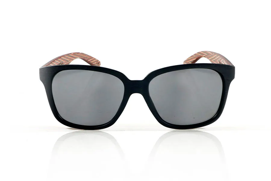 Wood eyewear of Zebrano PABLO. PABLO Sunglasses with laminated black Zebrawood (Black Ice Tree) temples with its characteristic light grain, and a multicolored skateboard-style interior. The matte black front adds a sober touch that contrasts with the vibrant interior, resulting in a modern and original design. Lightweight and comfortable for everyday wear, with polarized lenses and UV protection for greater comfort and visual safety. Measurements: 143 x 50 mm. Caliber 55. for Wholesale & Retail | Root Sunglasses® 