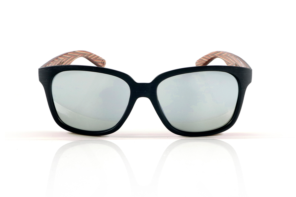 Wood eyewear of Zebrano PABLO. PABLO Sunglasses with laminated black Zebrawood (Black Ice Tree) temples with its characteristic light grain, and a multicolored skateboard-style interior. The matte black front adds a sober touch that contrasts with the vibrant interior, resulting in a modern and original design. Lightweight and comfortable for everyday wear, with polarized lenses and UV protection for greater comfort and visual safety. Measurements: 143 x 50 mm. Caliber 55. for Wholesale & Retail | Root Sunglasses® 