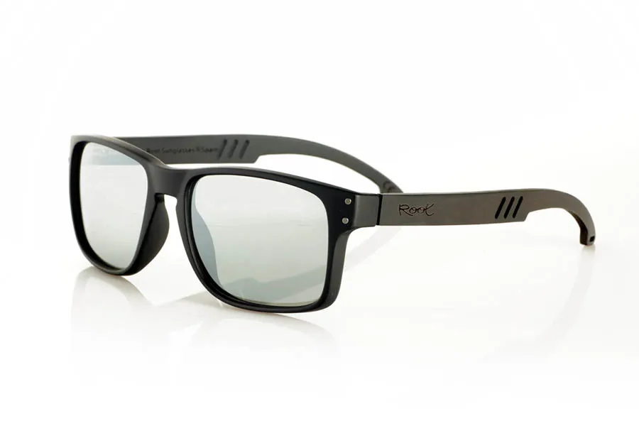 Wood eyewear of Ebony MATT. MATT Sunglasses with solid ebony wood temples and decorative temple. The matte black front features two metal dots on each side, reinforcing its modern and distinctive style. The die-cut temples add a distinctive touch. A robust, comfortable, and stylish model, equipped with blue mirror polarized lenses and UV protection. Measurements: 146 x 48 mm. Lens width: 55 mm. for Wholesale & Retail | Root Sunglasses® 