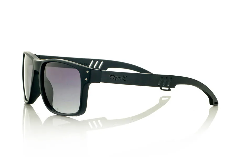 Wood eyewear of Ebony MATT. MATT Sunglasses with solid ebony wood temples and decorative temple. The matte black front features two metal dots on each side, reinforcing its modern and distinctive style. The die-cut temples add a distinctive touch. A robust, comfortable, and stylish model, equipped with blue mirror polarized lenses and UV protection. Measurements: 146 x 48 mm. Lens width: 55 mm. for Wholesale & Retail | Root Sunglasses® 