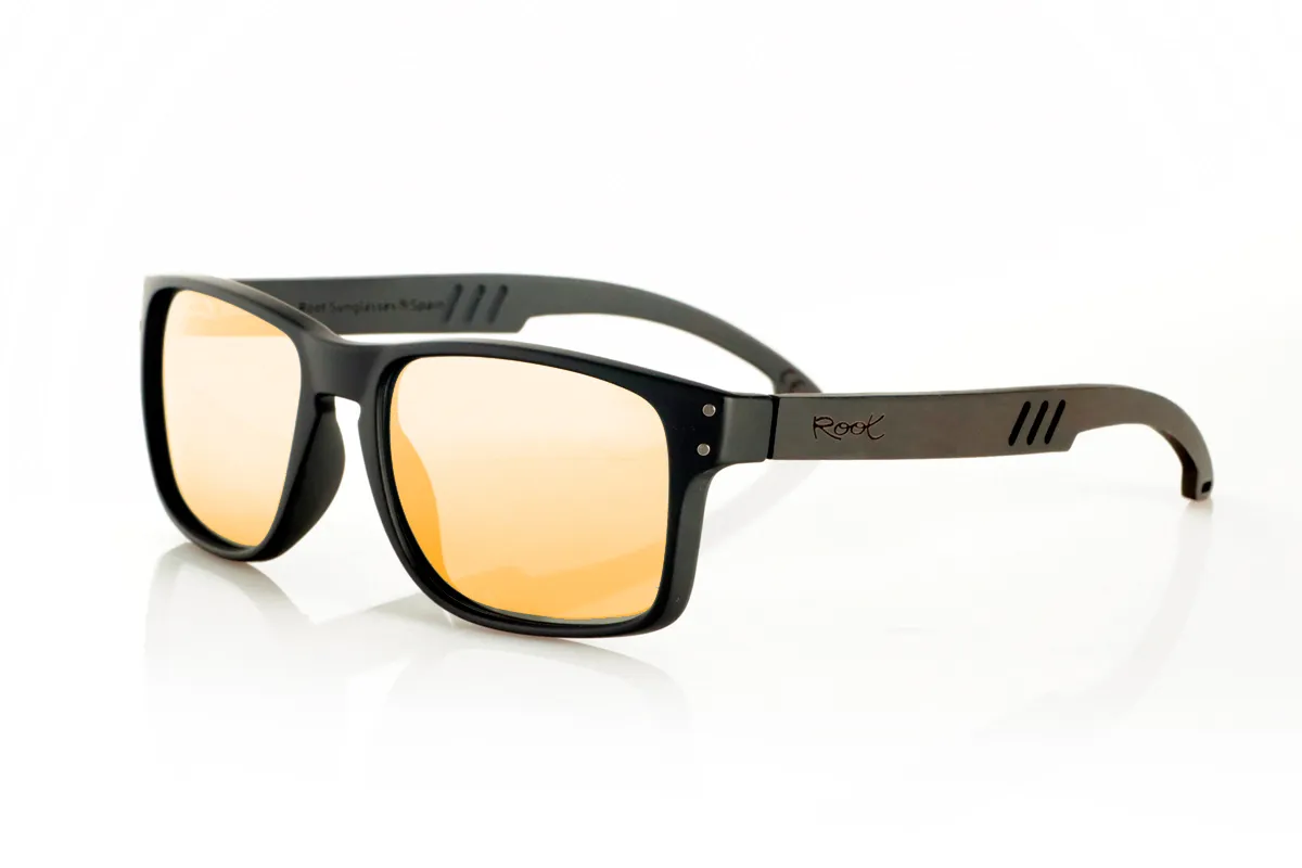 Wood eyewear of Ebony MATT. MATT Sunglasses with solid ebony wood temples and decorative temple. The matte black front features two metal dots on each side, reinforcing its modern and distinctive style. The die-cut temples add a distinctive touch. A robust, comfortable, and stylish model, equipped with blue mirror polarized lenses and UV protection. Measurements: 146 x 48 mm. Lens width: 55 mm. for Wholesale & Retail | Root Sunglasses® 