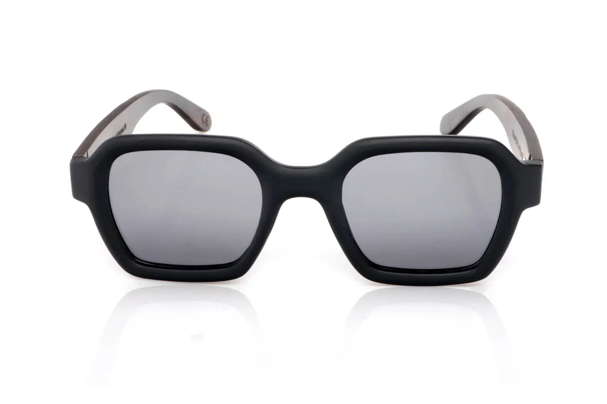 Wood eyewear of mpingo TRIMED. The TRIMED BLACK WOOD go for a more solid design, with a defined front and straight lines that add presence without losing balance. A soft square shape that structures the face and conveys character from the very first moment.

The Mpingo wood temples reinforce that natural feel, with visible grain and a finish that brings warmth against the stronger front. They are comfortable, stable and with a clear personality, made for those looking for something with more presence, without excess. You put them on and they define you.

Full UV protection.

Size: 142x49
Lens width: 48
 for Wholesale & Retail | Root Sunglasses® 