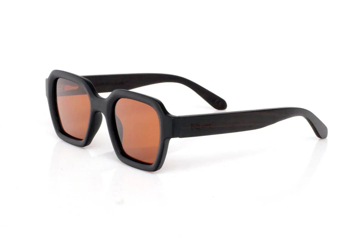 Wood eyewear of mpingo TRIMED. The TRIMED BLACK WOOD go for a more solid design, with a defined front and straight lines that add presence without losing balance. A soft square shape that structures the face and conveys character from the very first moment.

The Mpingo wood temples reinforce that natural feel, with visible grain and a finish that brings warmth against the stronger front. They are comfortable, stable and with a clear personality, made for those looking for something with more presence, without excess. You put them on and they define you.

Full UV protection.

Size: 142x49
Lens width: 48
 for Wholesale & Retail | Root Sunglasses® 